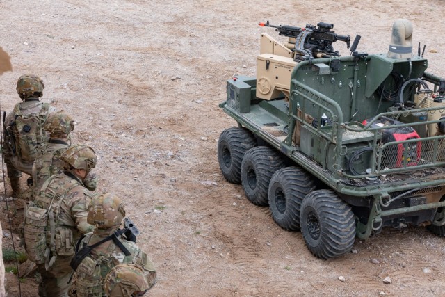 A U.S. Army unmanned, eight-wheeled, all-electric, all-terrain transport vehicle armed with the R600 autonomous weapon system provides support to dismounted Soldiers in an urban environment as part of a human integration experiment at Fort Irwin, Calif., March 12, 2024.