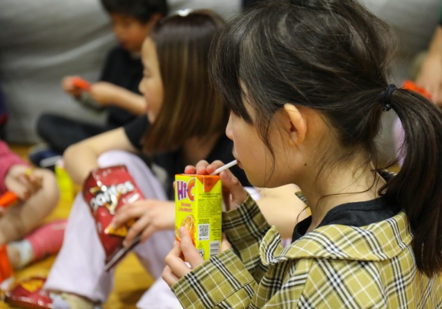 A child from the Sagamihara Minami Children’s Home enjoys some American snacks after playing dodgeball with community members during an outreach event at Camp Zama, Japan, April 3, 2024. 