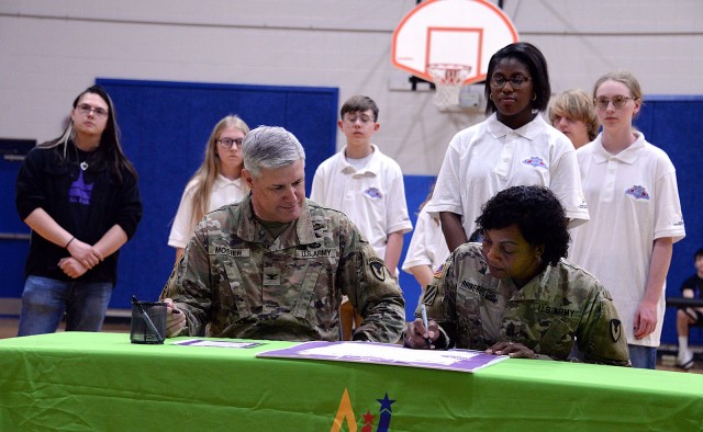 Fort Leavenworth, Kan., Garrison Commander Col. Duane Mosier and Garrison Command Sgt. Maj. Erika Rhine-Russell sign the 2024 Month of the Military Child proclamation during a MOMC kick-off assembly April 1 at Harrold Youth Center at Fort...