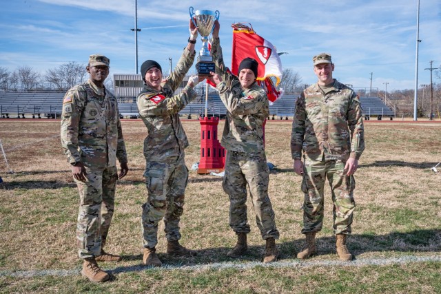 Capt. Robert Skinker (center, right) and 1st Lt. Luke Orsay, with the 5th Engineer Battalion, raise the Rugged Best Sapper Competition trophy, presented by Col. Aaron Cox, 36th Engineer Brigade commander (right), and 36th En. Bde. Command Sgt. Maj. Keyon Cummings Dec. 7 at Gerlach Field. Skinker and Orsay will be competing in the Best Sapper Competition April 19 to 22.