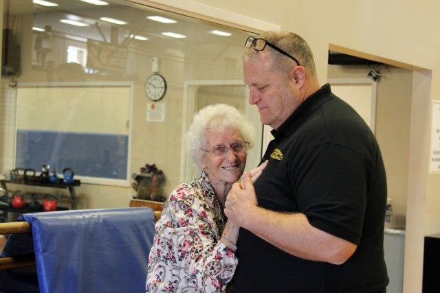 Cecilia Lesser dances with APG Survivor Outreach Services Coordinator Michael Farlow in Hoyle Gymnasium where she once attended NCO club dances with her late husband.