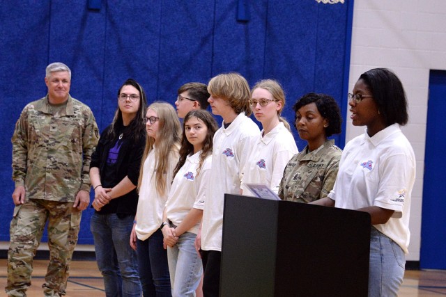 Fort Leavenworth, Kansas, Youth of the Year Rayna Klutse, right, senior at Leavenworth High School, reads the 2024 Month of the Military Child proclamation as Garrison Commander Col. Duane Mosier, Garrison Command Sgt. Maj. Erika Rhine-Russell ...