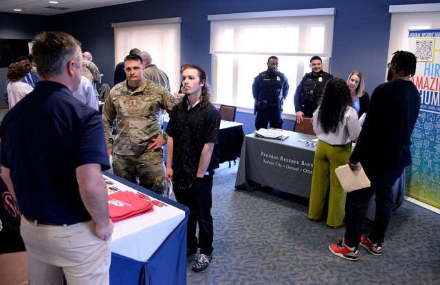 Sgt. Maj. Daniel Laakmann, Army Corrections Brigade, and 17-year-old Caden Laakmann talk with Nick Zorda, talent acquisition manager for Smith and Loveless Inc., a water and wastewater pumping company based in Lenexa, Kan., during the Career and...
