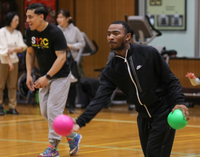 Sgt. Joshua McMath, right, a member of the Better Opportunities for Single Soldiers program, participates in a dodgeball game with children from the Sagamihara Minami Children’s Home during an outreach event at Camp Zama, Japan, April 3, 2024. McMath and other Soldiers also volunteered for a post cleanup the same day.
