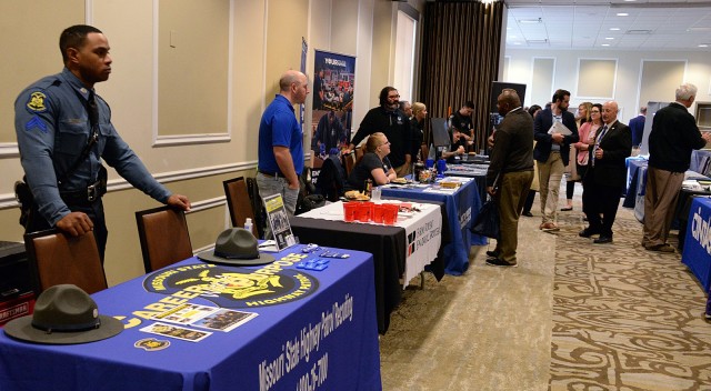 Fort Leavenworth Transition Services Manager Bob Jardon and Transition Services Specialist Lisa Fernholz browse the Career and Education Fair with Senate Committee on Veterans’ Affairs members Bradley Plukett, professional staff member; Asher...