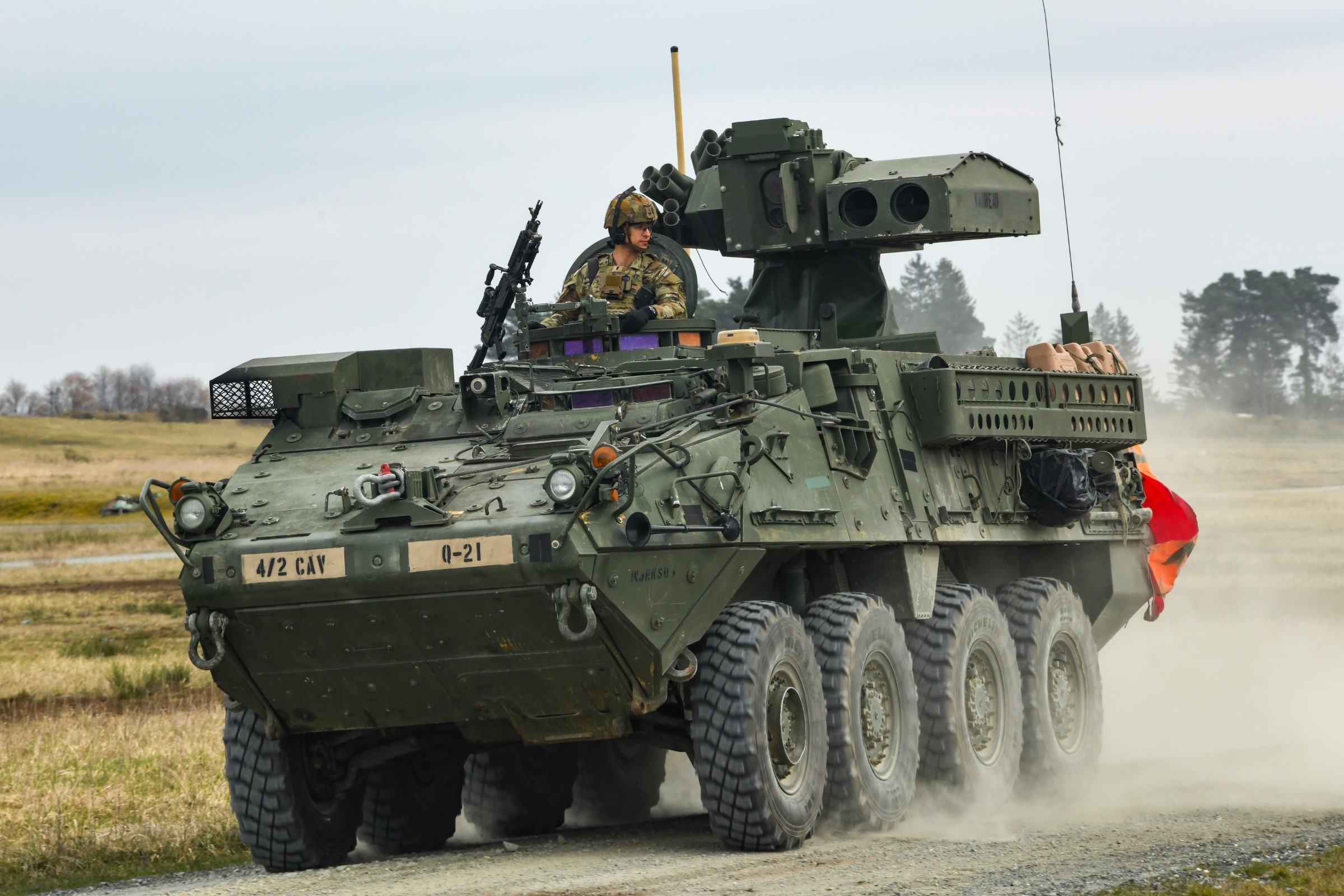 U.S. Soldiers, assigned to Quickstrike Troop, 4th Squadron, 2nd Cavalry Regiment, maneuver a Stryker down range during a tube-launched, optically-tracked, wireless-guided weapon system live fire exercise at the 7th Army Training Command&#39;s...