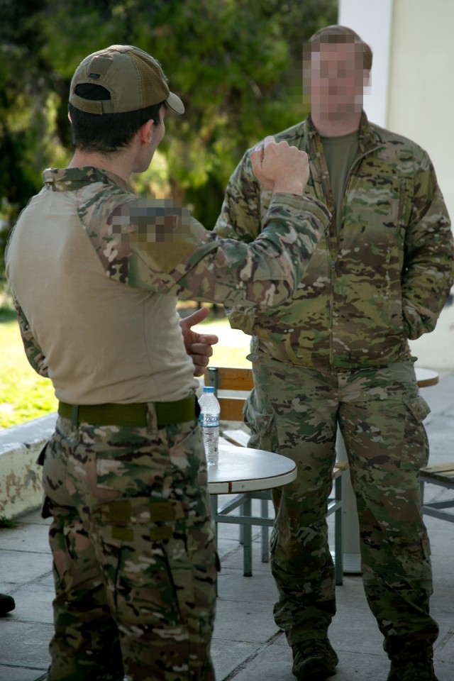 A Green Beret with 10th Special Forces Group (Airborne) and a Greek Special Operations Forces Operator discuss each other’s tactics, techniques and procedures during Exercise Trojan Footprint 24 near Nea Peramos, Greece, March 4, 2024. The...