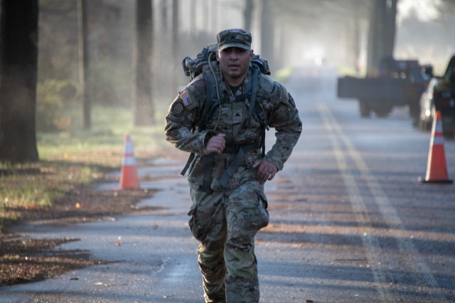 Staff Sgt. Vance Yazzie, a parachute rigger with U.S. Army Combat Capabilities Development Command, or DEVCOM, Soldier Center, crosses the finish line of the 8-mile foot march as part of the DEVCOM Best Warrior Competition April 4, 2024, at Aberdeen Proving Ground, Maryland. The foot march was the last event of the competition. 