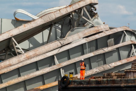 A salvage operator assesses debris as salvage operations continue in Baltimore on April 6, 2024. Response efforts are ongoing following the Francis Scott Key Bridge collapse.