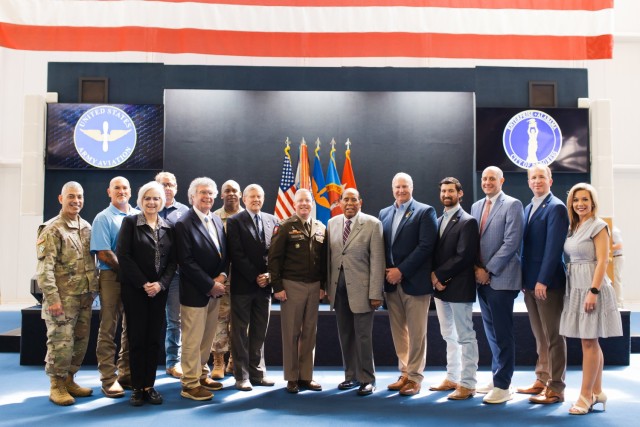 Representatives from the United States Army Aviation Center of Excellence and Fort Novosel as well as representatives from the City of Enterprise pose for a group photo at the conclusion of the IGSA signing ceremony at the Army Aviation Museum on April 8 on Fort Novosel. 