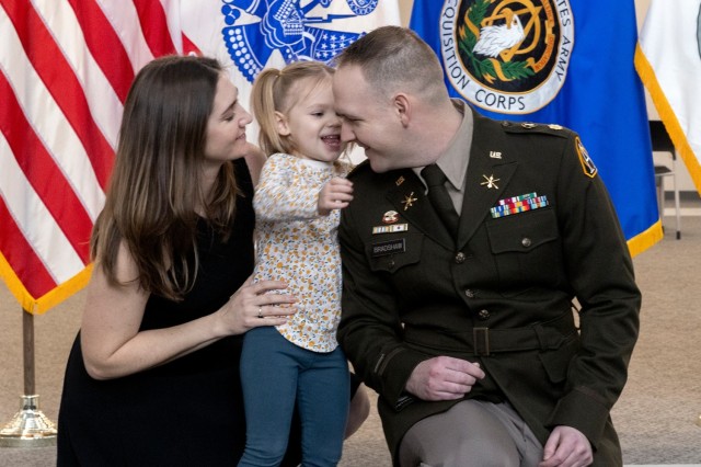 PICATINNY ARSENAL, N.J. - Maj. Andrew T. Brashaw, Assistant Product Manager Crew Served Weapons, part of Project Manager Soldier Lethality, and his wife, Capt. Catherine M. Bradshaw, aide-de-camp, Joint Program Executive Office for Armaments and Ammunition, with their daughter Averie.