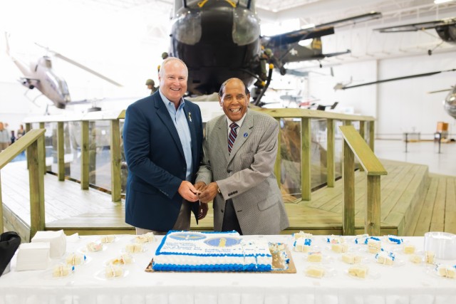 Billy Powell, Director of Enterprise Parks and Recreation and Mayor William E. Cooper from the City of Enterprise cut the ceremonial cake at the reception that followed the IGSA signing ceremony at the Army Aviation Museum on April 8 on Fort Novosel. 