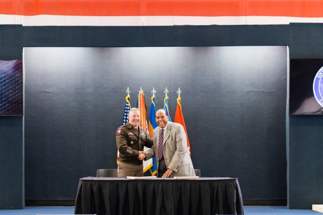 Maj. Gen. Michael C. McCurry, commanding general of the United States Army Aviation Center of Excellence and Fort Novosel, and the Mayor of Enterprise, Ala. William E. Cooper shake hands after the signing of the IGSA agreement between Fort Novosel and the City of Enterprise on April 8 at the Army Aviation Museum on Fort Novosel. 