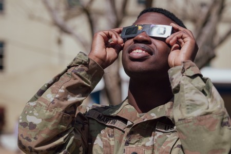 U.S. Army Spc. Joseph Martin takes a break from work to witness a partial solar eclipse over the Pentagon in Arlington, Va., April 8, 2024.