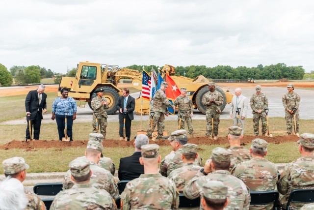 The official groundbreaking team (left to right) Mike Waller, Miranda Griffin, Staff Sgt. Katherine Ransom, Jonathan Cole, Col. John Miller, Maj. Gen. Michael C. McCurry, Command Sgt. Maj. Kirck Coley, John Watson, Command Sgt. Maj. Michael McAvoy, and Pfc. Ica Miles Mendiola celebrate after taking the first dig into soil for the Fort Novosel AIT barracks complex project on April 10, 2024.