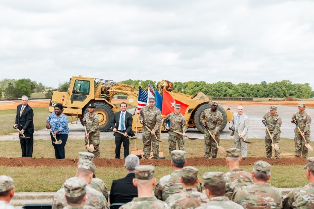 The official groundbreaking team (left to right) Mike Waller, Miranda Griffin, Staff Sgt. Katherine Ransom, Jonathan Cole, Col. John Miller, Maj. Gen. Michael C. McCurry, Command Sgt. Maj. Kirck Coley, John Watson, Command Sgt. Maj. Michael McAvoy, and Pfc.  Ica Miles Mendiola take the first dig into soil for the Fort Novosel AIT barracks complex project on April 10, 2024. 