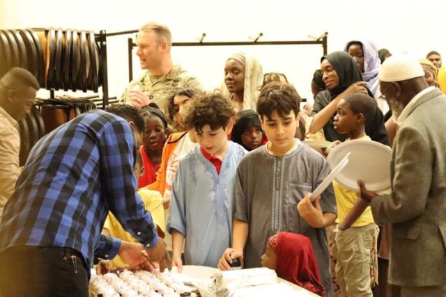 Members of the crowd at the Iftar event eye sweets, such as cupcakes, April 5, 2024, at Fort Cavazos, Texas.