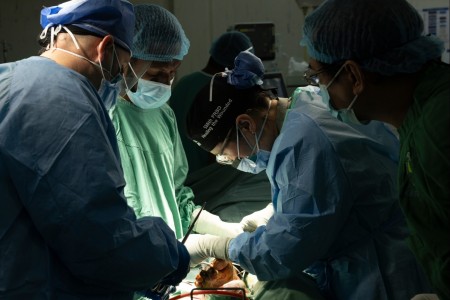 (r) U.S. Army Maj. Priscilla Cha, general surgeon, along with other members of the 135th Forward Resuscitative and Surgical Detachment, 65th Medical Brigade, and a Port Moresby General Hospital surgical team perform an amputation in POMGEN’s Hospital during Trauma Rotation-Papua New Guinea at Port Moresby, Papua New Guinea, April 9, 2024. Trauma Rotation-Papua New Guinea is one of the numerous global health engagements the 18th Medical Command facilitates in support of U.S. Army Pacific’s overarching medical security cooperation strategy throughout the Indo-Pacific. 18th MEDCOM sets the Joint theater for medical operations while increasing its strategic posture by synchronizing and coordinating health service support and medical logistics across its more than 4,000 square mile area of responsibility.