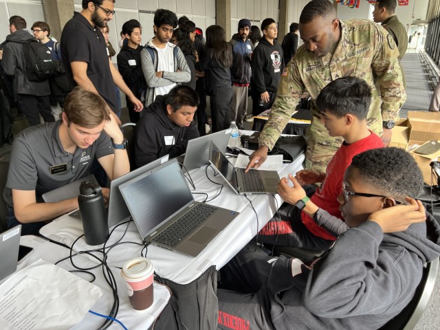 Sgt. Gregory Braveboy, a cyberspace operations noncommissioned officer, engages undergraduate and graduate students from Illinois Tech and some ROTC cadets during a job fair at the Chicago Cyber Conference, March 31, 2023. 