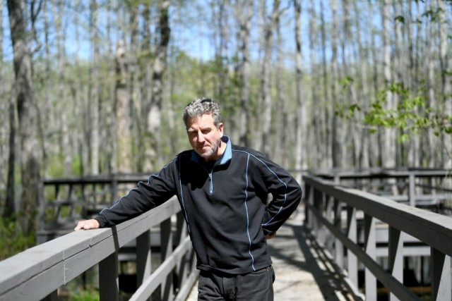 Tom Richardson, standing Friday in the scenic grounds near the Outdoor Learning Center, is the Garrison’s environmental branch chief. The Arbor Day Foundation has recognized Redstone Arsenal as a Tree City USA for the 17th consecutive year.
