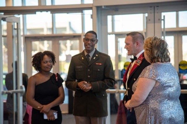 From left, Andreanna and Ezekiel Burwell talk with Garrison Commander Col. Brian Cozine and his wife, Stacey.