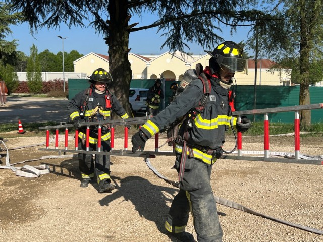 USAG Italy rookie firefighters take part in training for their Fire Fighter certifications on April 12 in the Villiaggio housing area. The scenario focused on rescuing victims in a simulated burning house and then rescuing a fellow firefighter through heavy smoke. 