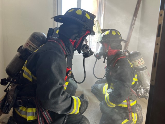 USAG Italy rookie firefighters take part in training for their Fire Fighter certifications on April 12 in the Villiaggio housing area. The scenario focused on rescuing victims in a simulated burning house and then rescuing a fellow firefighter through heavy smoke. 