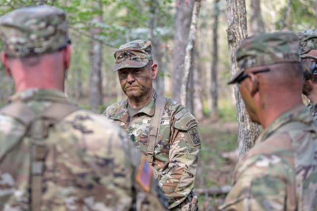 Sgt. Maj. of the Army Michael Weimer speaks with 1st Engineer Brigade Soldiers April 18 at Training Area 239 while observing cadre and trainees with Company D, 31st Engineer Battalion, participating in the Army’s new basic combat training culminating event concept, called Forge 2.5. The SMA visited Fort Leonard Wood this week to engage with leaders and Soldiers, observe training and tour facilities.