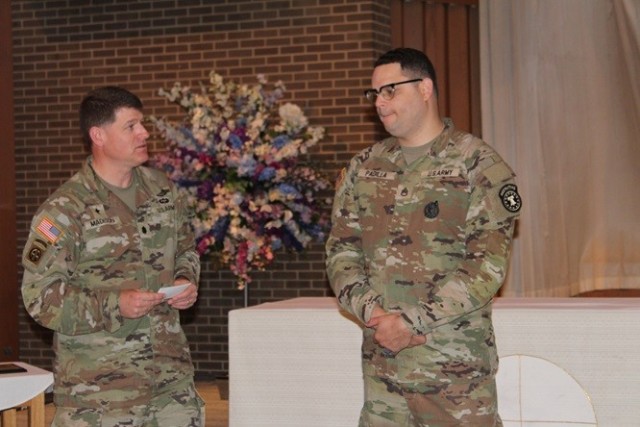 Garrison Chaplain (Lt. Col.) Matt Madison praises Staff Sgt. Jorge Padilla during April 12’s sendoff where Padilla received two Army Commendation Medals. 

