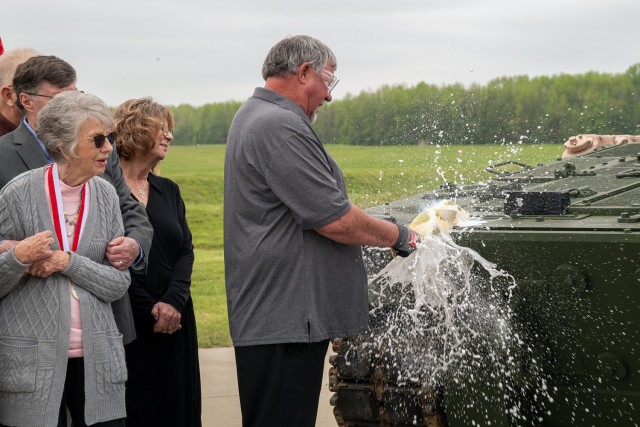 Family members of U.S. Army Pvt. Robert D. Booker breaks a bottle Champagne on the front of the M10 Booker Combat Vehicle during the official christening and M10 Booker Dedication Ceremony at Aberdeen Proving Ground, in Aberdeen, Md., April 18, 2024. Also participating in the christening ceremony were: Brig. Gen. Wilson and Command Sgt. Maj. Reffeor, both with the 3rd Infantry Division, joined by Command Sgt. Maj. Luck and Sgt. Maj. Queck, both with the 34th Infantry Division.