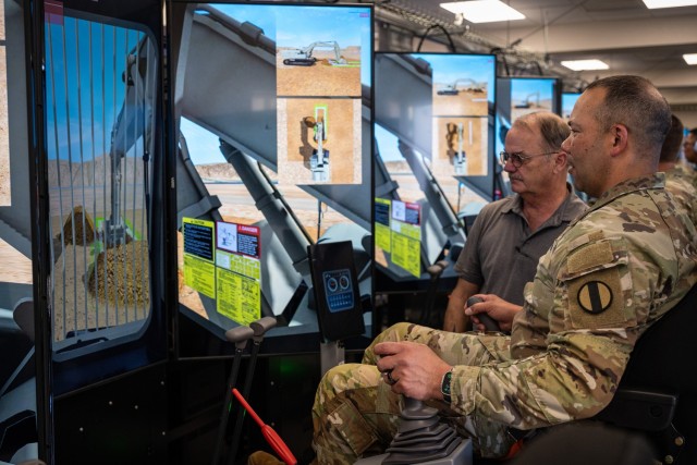 Russell Kurfman, the U.S. Army Engineer School Horizontal Skills Annex chief, teaches U.S. Army Training and Doctrine Command’s Command Sgt. Maj. Raymond Harris how to operate a hydraulic excavator simulator April 17 at Training Area 244 during...