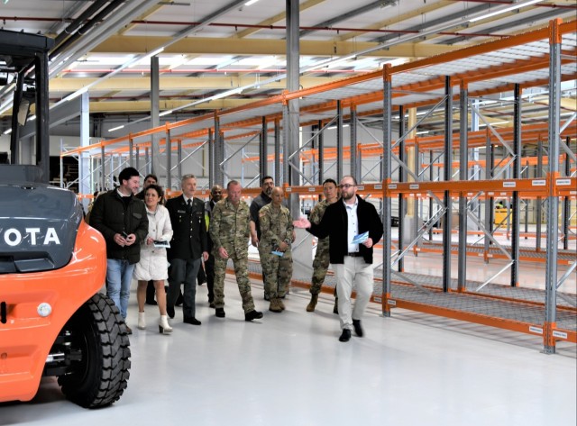 A group of individuals getting a tour inside a newly renovated warehouse that will be reserved for future use of medical materiel. 