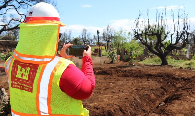 Lillian Corley, Quality Assurance representative from the Sacramento District, member of the U.S. Army Corps of Engineers Debris Planning and Response Team on Maui, Hawaii takes a photo of a property in the Lahaina impact zone cleared of fire...