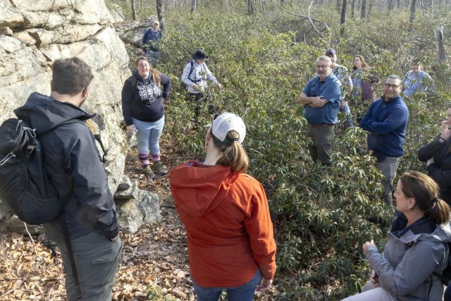 PICATINNY ARSENAL, N.J. - Rachael Winston (far left), Picatinny Arsenal Cultural Resource Manager points out a dry-laid stone feature identified in 2021 during an archaeological survey on the installation, to visiting Cultural Resource Managers....