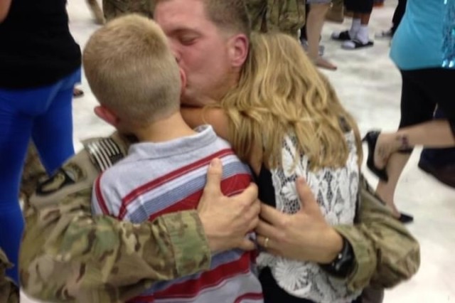 U.S. Army Maj. Everett (Bud) Lacroix is warmly embraced by his two military children after an emotional return from a deployment with 1st Brigade Combat Team, 101st Airborne Division in Aug. 2013. This deployment was Lacroix&#39;s third of five deployments to Iraq and Afghanistan. Lacroix currently works as the support operations officer for the 21st Theater Sustainment Command in Kaiserslautern, Germany. 