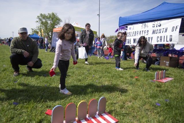 Four-year-old Octavia Lorau, and her six-year-old brother, Dawson, play a beanbag game put on by employees with Child Development Center 615 April 20 on Gerlach Field during one of Fort Leonard Wood’s largest Month of the Military Child events,...