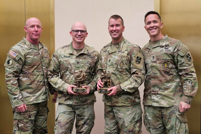 Master Sgt. Ryan Owens (center right) and Sgt. 1st Class James Yeakey (center left), from the Fort Leonard Wood Army National Guard Liaison Program Office, pose for a photo with Sgts. Maj. Joshua Beach (left) and Daniel Neville (right) March 14 at the Director’s Strength Maintenance Awards Conference in Houston, Texas, with the awards they were presented as U.S. Army Training and Doctrine Command’s top Army National Guard Liaison NCO in charge and Army National Guard Liaison NCO, respectively. Army National Guard liaison NCOs help ensure quality Soldiers are retained by assisting, advising and supporting trainees and commanders throughout initial entry training. 