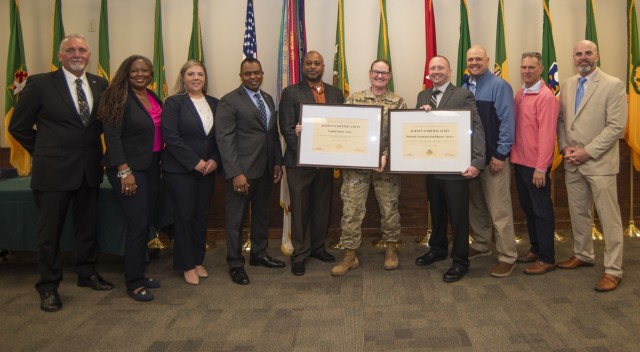 At a ceremony April 24 in the Military Police Regimental Room at the John B. Mahaffey Museum Complex, Maceo Franks, director of the Department of Defense Peace Officer Standards and Training Commission and chief of the Law Enforcement Division within the Office of the Under Secretary of Defense for Intelligence and Security (fourth from left) poses for a photo with senior leaders of the Army and National Geospatial-Intelligence Agency law enforcement community after presenting POST Commission certificates signifying each organizations’ meeting of DOD law enforcement standards. 