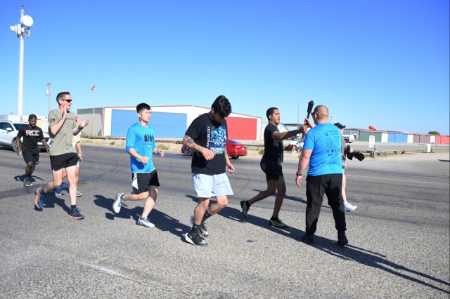 The nearly 20 Soldiers from the Airborne Test Force, Medical Clinic, Veterinary Clinic, and Chapel jogged two miles, including uphill, with the torch in hand in support the annual Law Enforcement Torch Run for Special Olympics Arizona on the morning of April 25, 2024.