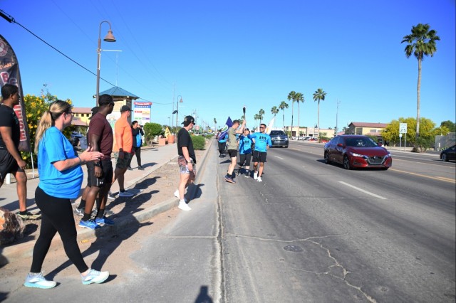 The nearly 20 Soldiers from the Airborne Test Force, Medical Clinic, Veterinary Clinic, and Chapel jogged two miles, including uphill, with the torch in hand in support the annual Law Enforcement Torch Run for Special Olympics Arizona on the morning of April 25, 2024.