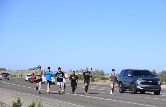 The nearly 20 Soldiers from the Airborne Test Force, Medical Clinic, Veterinary Clinic, and Chapel jogged two miles, including uphill, with the torch in hand in support the annual Law Enforcement Torch Run for Special Olympics Arizona on the morning of April 25, 2024.