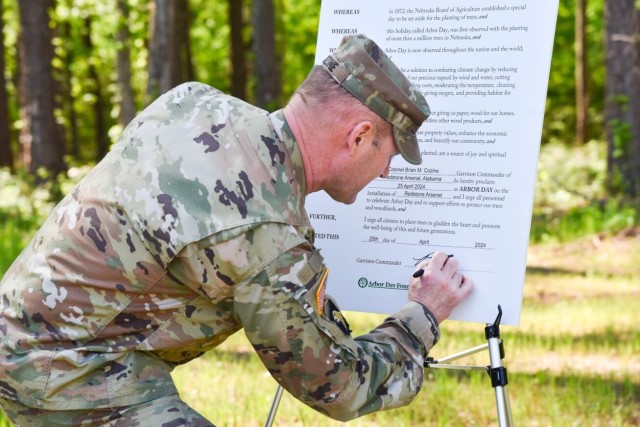 Garrison Commander Col. Brian Cozine signs the Earth Day proclamation Thursday at the Outdoor Learning Center.
