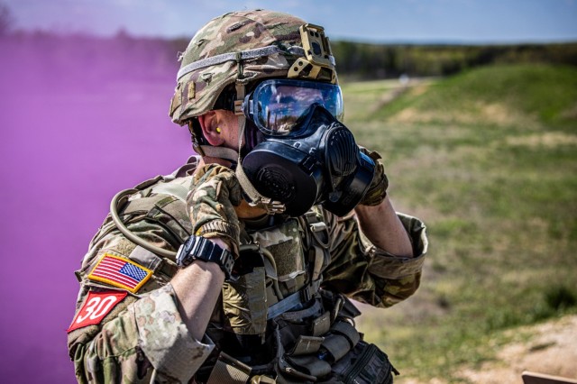 A U.S. Army Soldier dawns his protective mask before engaging targets with an M2A1 machine gun, as part of a stress shoot on day 3 of the 2024 Best Sapper Competition, at Fort Leonard Wood, Missouri, April 21, 2024.