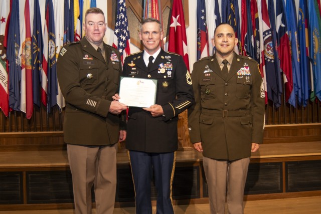 At an April 29 ceremony in Lincoln Hall Auditorium, Maj. Gen. Christopher Beck, Maneuver Support Center of Excellence and Fort Leonard Wood commanding general (left), and MSCoE and Fort Leonard Wood Command Sgt. Maj. Jorge Arzabala (right) present the Soldier’s Medal to Sgt. 1st Class Matthew Mobley for life-saving actions, when a motorist was trapped in a burning car in January 2021, in Crocker, Missouri. Mobley, who just completed the Army’s Career Skills Program, is set to retire May 31.