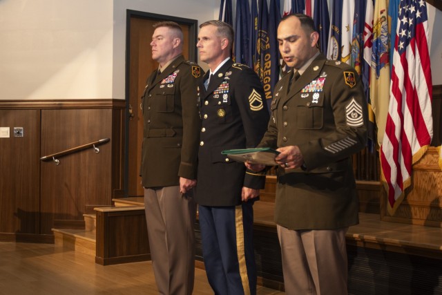 At an April 29 ceremony in Lincoln Hall Auditorium, Maj. Gen. Christopher Beck, Maneuver Support Center of Excellence and Fort Leonard Wood commanding general (left), and MSCoE and Fort Leonard Wood Command Sgt. Maj. Jorge Arzabala (right) present the Soldier’s Medal to Sgt. 1st Class Matthew Mobley for life-saving actions, when a motorist was trapped in a burning car in January 2021, in Crocker, Missouri. Mobley, who just completed the Army’s Career Skills Program, is set to retire May 31.