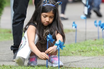 Youth display pinwheels to promote prevention of child abuse