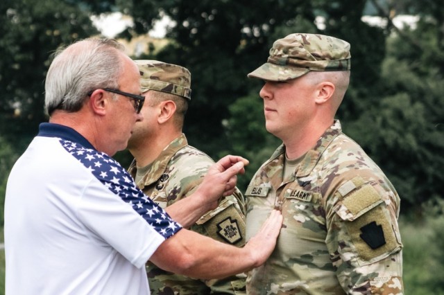 Joseph Ellis, right, who was promoted from sergeant to staff sergeant, gets his new rank was pinned on by his father during a ceremony at Fort Indiantown Gap, on July 9, 2023. 