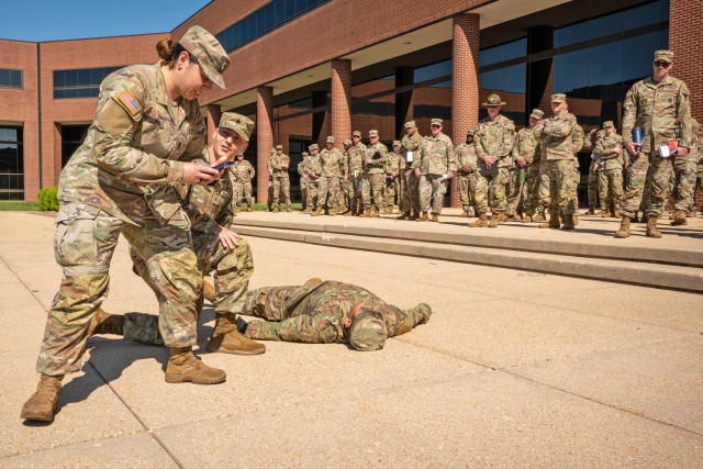 As part of the heat forum April 30 at Lincoln Hall Auditorium, Soldiers demonstrate a heat causality event on the Maneuver Support Center of Excellence Plaza. In the demonstration, Pfc. Henry Basilio Gomez, from Company C, 554th Engineer...