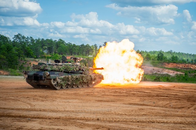 An Abrams tank fires on a simulated enemy position on Red Cloud Range at Fort Moore, Ga., April 27, 2024, during Operation Thunderstrike, a live fire demonstration featuring tanks, Strykers, mortars, drones, and Bradleys. Operation Thunderstrike, the kick off to Armor Week 2024, is the first in a series of spectator events during the Sullivan Cup, an armor competition that will determine the best Abrams tank and Bradley Fighting Vehicle crews in the world.