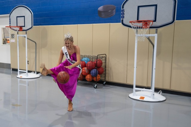Hanley House, Miss America's Teen 2024, dribbles a basketball at Fort Knox, Kentucky May 2, 2024. While visiting the installation House had the opporunity to meet with many installation students and children and interact with them.